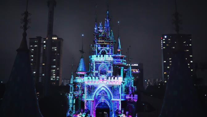 Bright images are projection mapped onto Magic Castle at Lotte World’s Magic Island. Photo courtesy of d’strict 