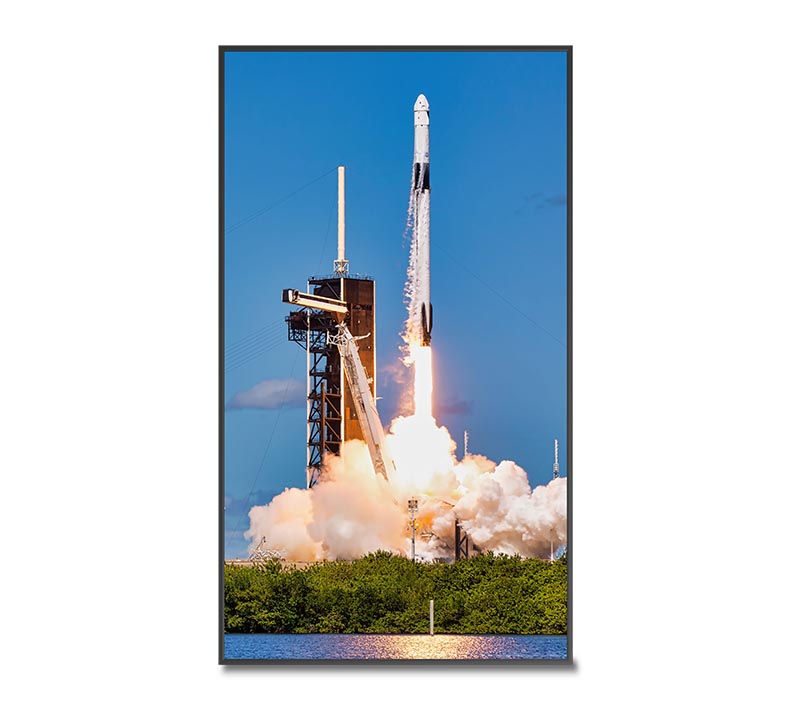 A Christie Secure Series III LCD panel in portrait orientation displaying an image of a rocket.