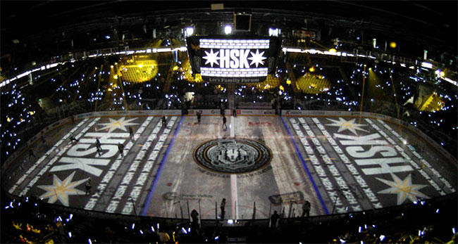 A large ice rink displays projection-mapped content.