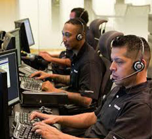 Christie tech support team wearing phone headsets and working on computers