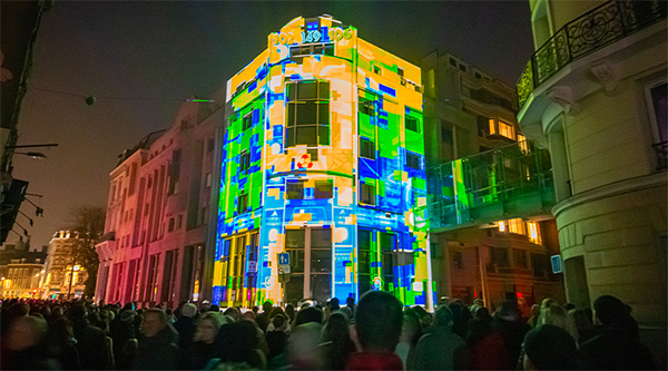 A pattern of yellow, green and blue projected onto the Crédit Mutuel Nord Europe building 